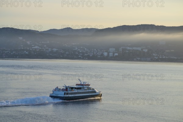 Ferry crossing the North Sea in the light of sunrise, with Bergen in the background, Bergen,