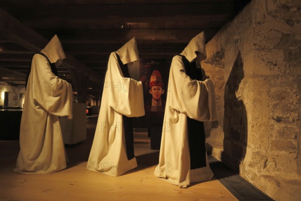 Three historical monks with monk's cowl and hoods in the museum, figures, cowl, Middle Ages,