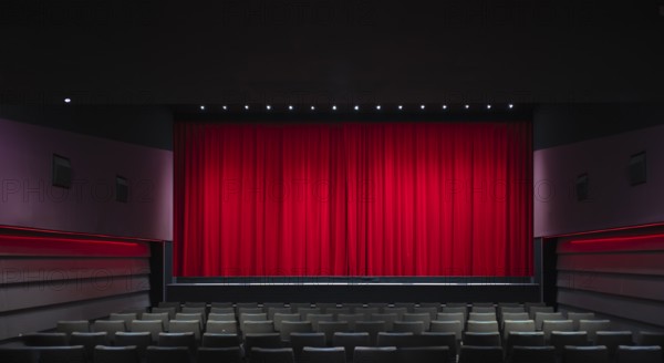 Interior shot, red velvet curtain in a cinema, theatre, rows of seats, Stuttgart,
