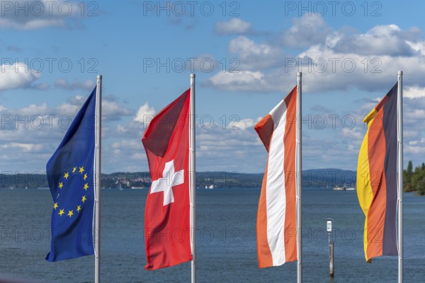 Waving flags, Europe, Switzerland, Austria, cityscape, blue sky, Hagnau on Lake Constance,