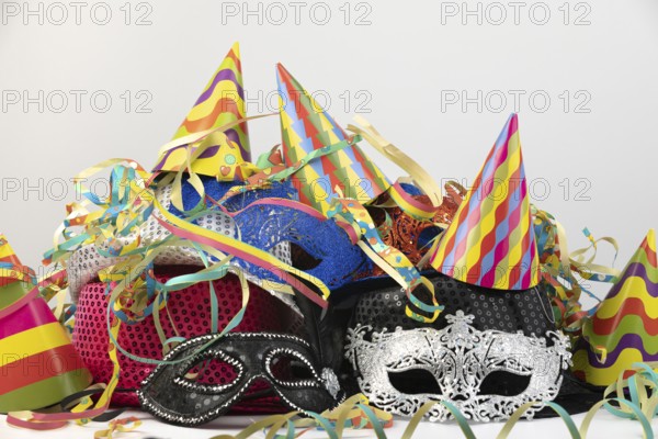 Colourful party hats and carnival masks, decorated with colourful streamers, carnival