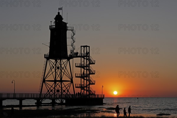 Sunset, lighthouse Obereversand, silhouettes, people, North Sea, Dorum-Neufeld, Wurster Land, Lower