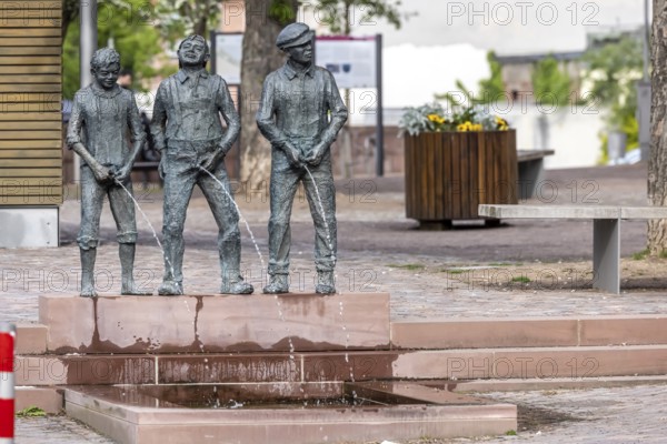 Staffelbrunserbrunnen Miltenberg. The fountain figures depict three boys urinating in a pool of