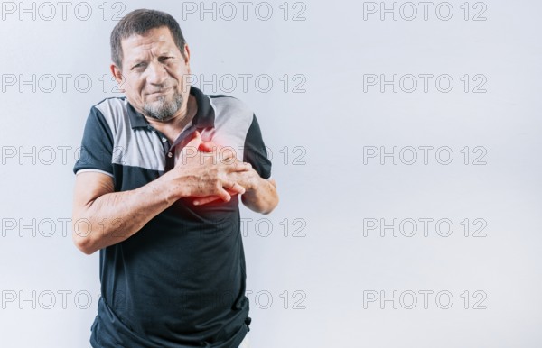Senior man with tachycardia touching his chest. Elderly person with heart problems. Old man with