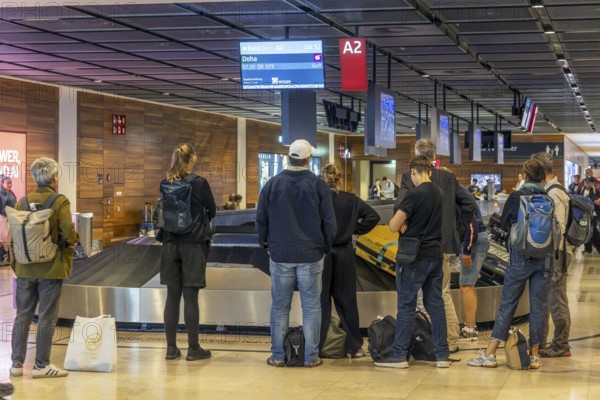 Berlin-Brandenburg BER Airport. Passengers waiting for their suitcases at baggage reclaim. Berlin,