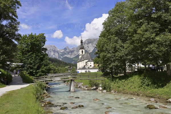 Parish church of St. Sebastian in autumn with Ramsauer Ache, Reiteralpe in the background, Ramsau,