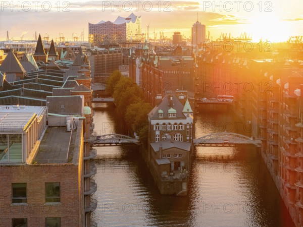 Aerial view of Speicherstadt Hamburg with Fleetschlösschen and Elbe Philharmonic Hall at sunset,