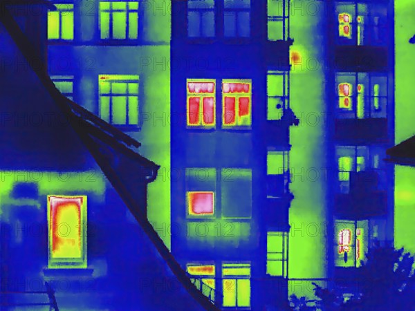 Apartment block, facade of a residential building with windows. Thermal image or thermography,