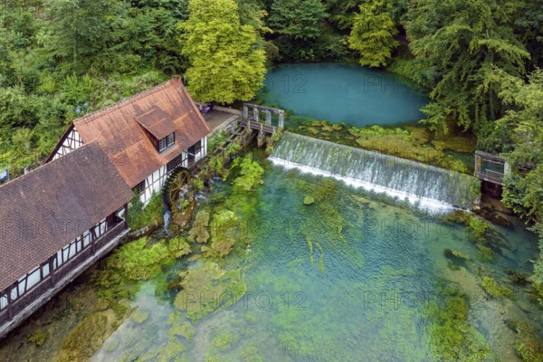Blautopf Blaubeuren with industrial monument Hammerschmiede, source of the little river Blau in a