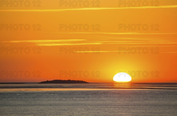Picturesque, golden, magnificently beautiful sunset over the sea, Langlütjen II island far away,