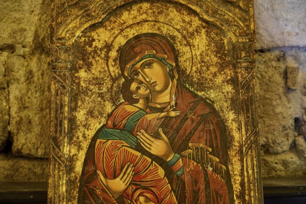Icon with Mary and baby Jesus against a brick background, gilded accents, Monastery of Our Lady of