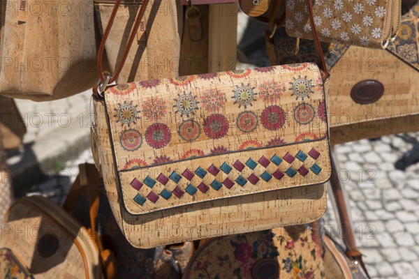 Close-up of a handbag with detailed pattern and bright colours, showing handicraft work at a