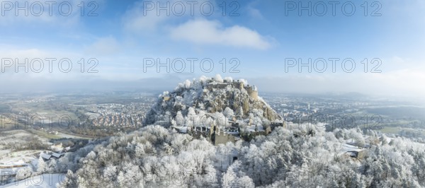 Aerial panorama of the snow-covered Hegau volcano Hohentwiel with Germany's largest castle ruins,