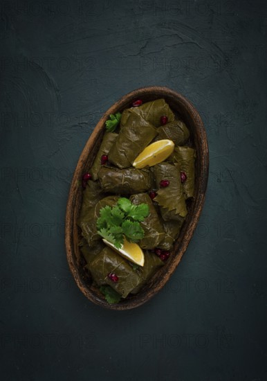 Dolma (Tolma) stuffed rolls, minced meat with rice, in grape leaves, top view, no people, close-up