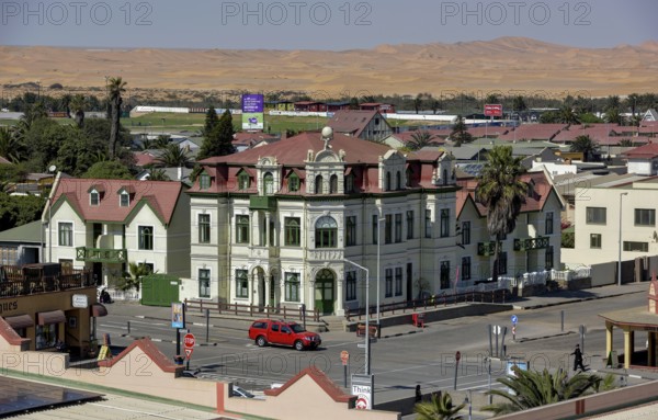 Hohenzollernhaus from 1906, neo-baroque, in the background dunes of the Namib desert, Swakopmund,