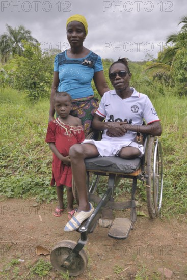 Amputee with his wife and child, Motema Amputee Camp, Koidu, Koidu-Sefadu, Kono District, Eastern