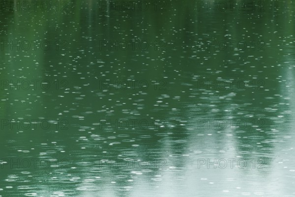 Raindrops on emerald green reservoir, Stillup reservoir, Stilluptal, Mayrhofen, High Mountain