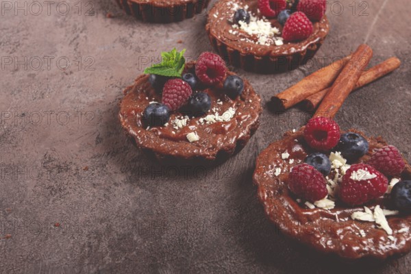 Chocolate tartlets, stuffed with cottage cheese and berries, breakfast, homemade, no people