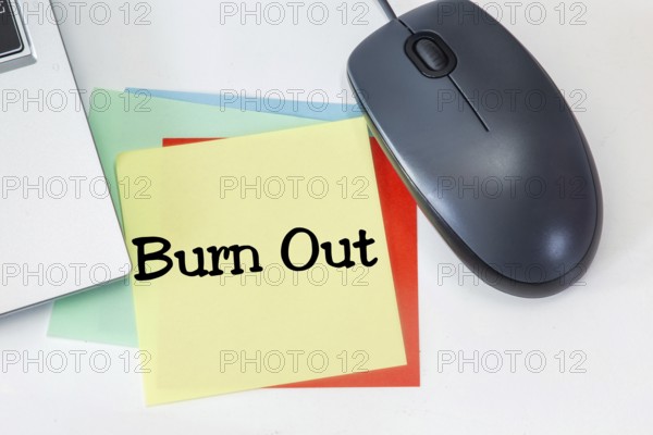 Note with the inscription BURN OUT on a desk
