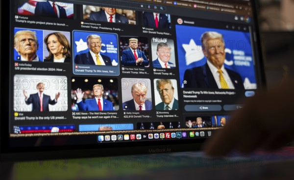 In this photo illustration, a person looks Donald Trump news on a laptop after results of U.S.