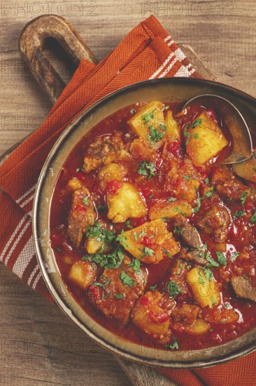 Potatoes with meat, stewed in tomato sauce, with spices and herbs, homemade, no people