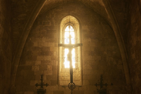 Chancel of the monastery church, window of a church with sunlight on a cross, Gothic style,