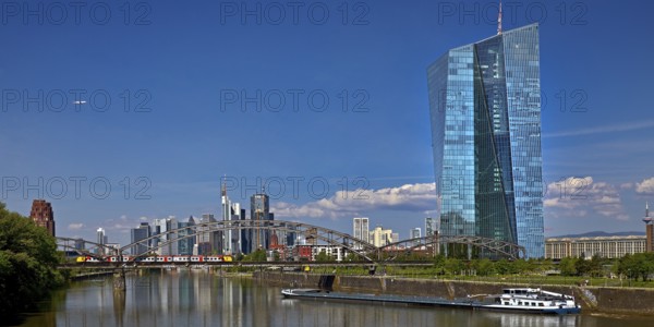 ECB European Central Bank with cargo ship on the river Main and the skyline of Frankfurt am Main,