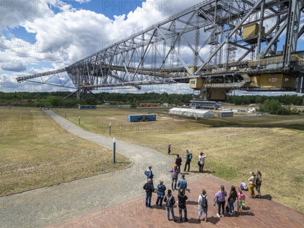 Visitor group below conveyer brigde F60 in Lichterfeld, now a museum left after coal mining. Two