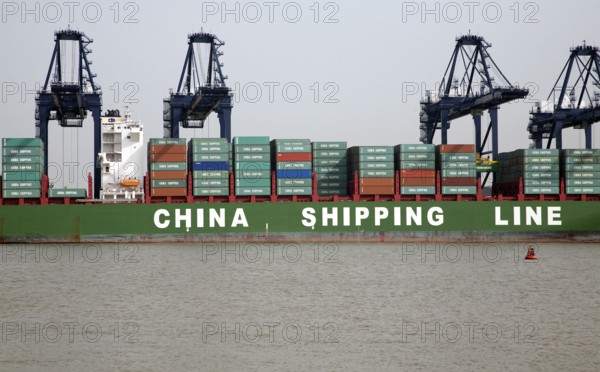 Cranes unloading containers China Shipping Line container ship, Port of Felixstowe, Suffolk,