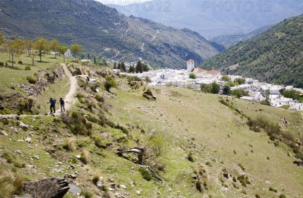Walkers near the village of Capileira, High Alpujarras, Sierra Nevada, Granada province, Spain,