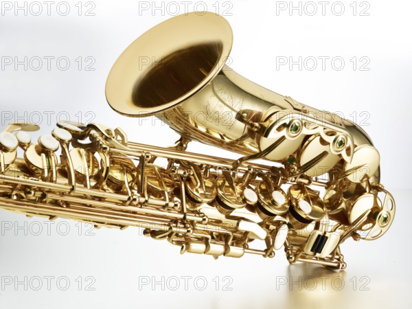 Saxophone in front of white background, detail, studio shot