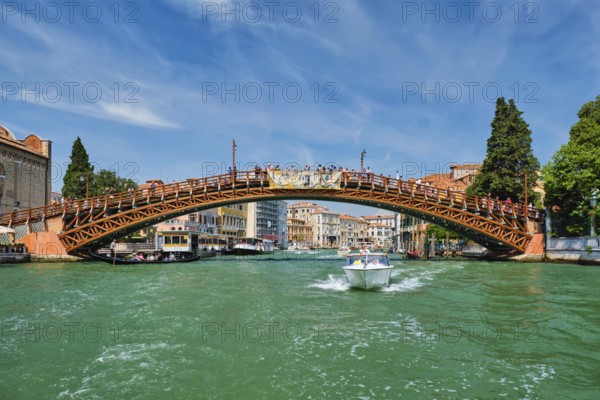 VENICE, ITALY, JULY 19, 2019: Ponte dell'Accademia bridge with boat passing under on Grand Canal,