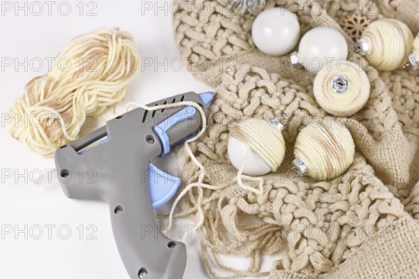 DIY boho style Christmas bauble ornaments with with cream colored cord attached to balls with hot