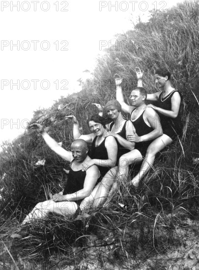 Bathing group, five sat in the dunes and raise their hands, funny, laughing, summer holidays,