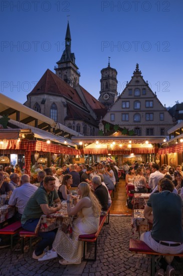 People sitting in wine arbours in the evening, Weindorf Stuttgart, Schillerplatz, collegiate