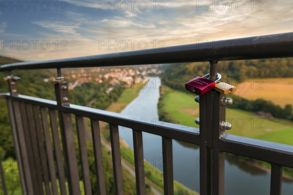 Two love locks on the railing, view from the skywalk onto the Weser towards Bad Karlshafen in the