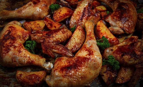 Roast chicken legs with potatoes and onions in the oven, homemade. No people