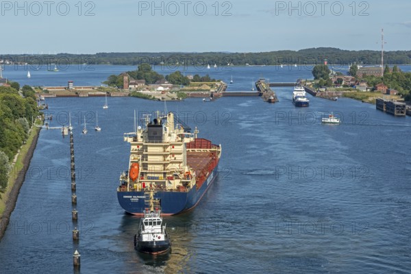 Cargo ship waiting in front of the lock, tugboat, Kiel Canal, Holtenau, Kiel, Schleswig-Holstein,