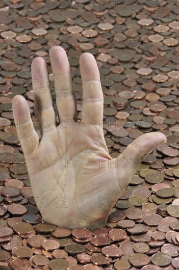 Man disappearing in euro coins while sticking hand out for help