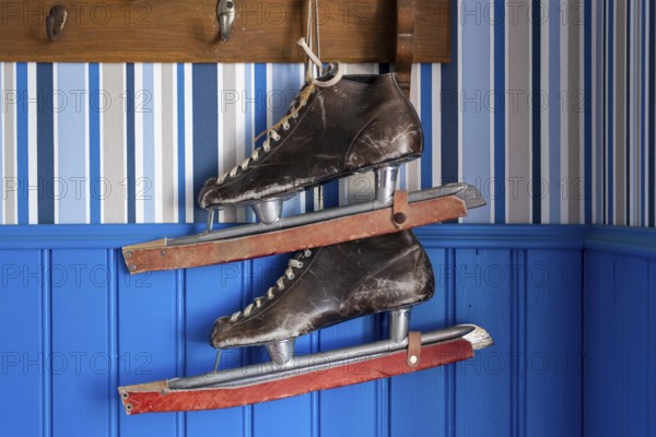 Old leather skates on a blue wall, Naantali or Nådendal, Baltic Sea coast, Finland, Europe