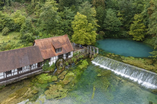 Blautopf Blaubeuren with industrial monument Hammerschmiede, source of the little river Blau in a