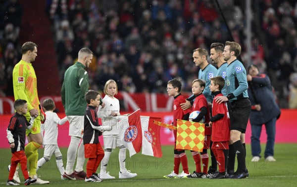 Ball kids, line up in front of kick-off of a Bundesliga match, referee team around referee Daniel