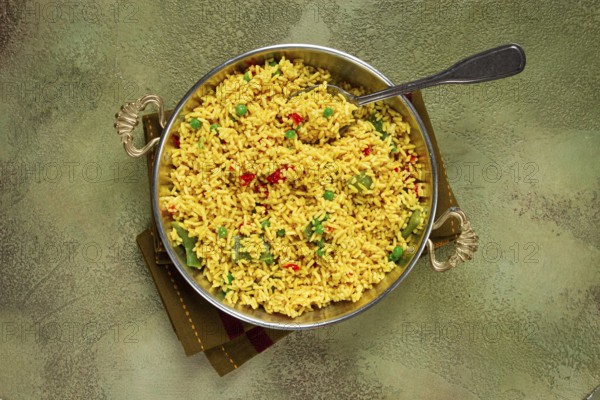 Rice with saffron and vegetables, in a frying pan, top view, homemade, no people