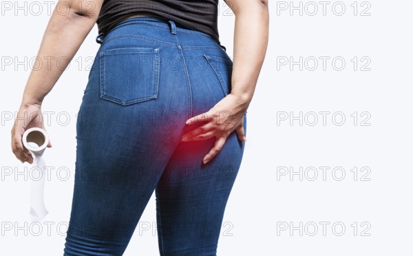 Girl with digestive problem touching buttock isolated holding toilet paper. Woman with diarrhea