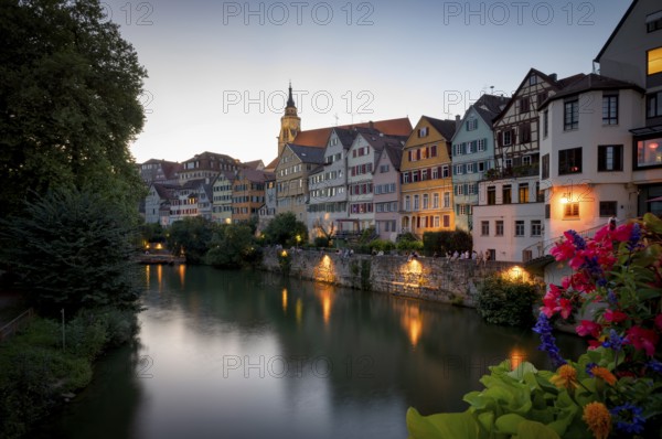 View in summer from the Neckar bridge onto the Neckar front with historic buildings, collegiate