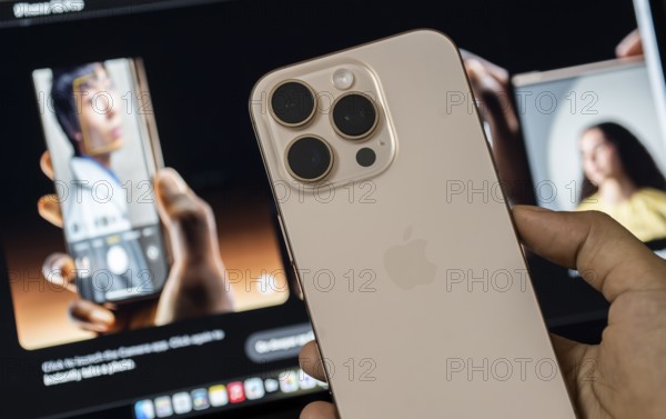 A person holding an iphone 16 series device at an apple premium reseller store, as iPhone 16 series