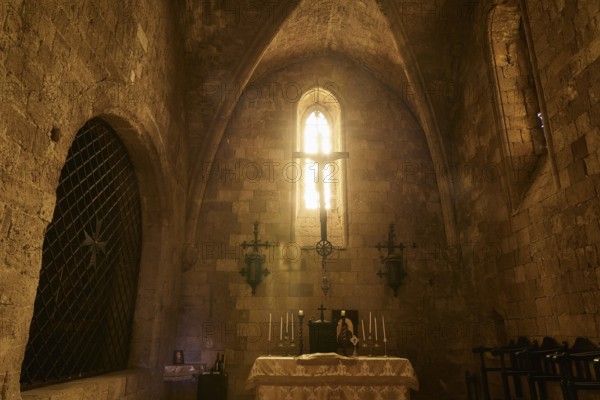 Chancel of the monastery church, interior of a church with illuminated altar and Gothic window,