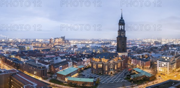 Panorama aerial view of St. Michael's Church (Michel) at blue hour with harbour and Elbe