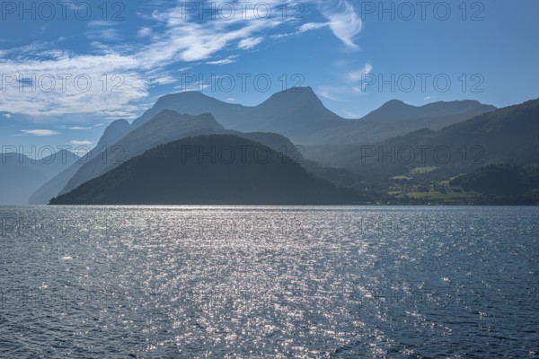 Norddalsfjord, view from the Linge ferry terminal to the south, backlit mountain ranges, near