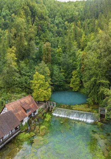 Blautopf Blaubeuren with industrial monument Hammerschmiede, source of the little river Blau in a